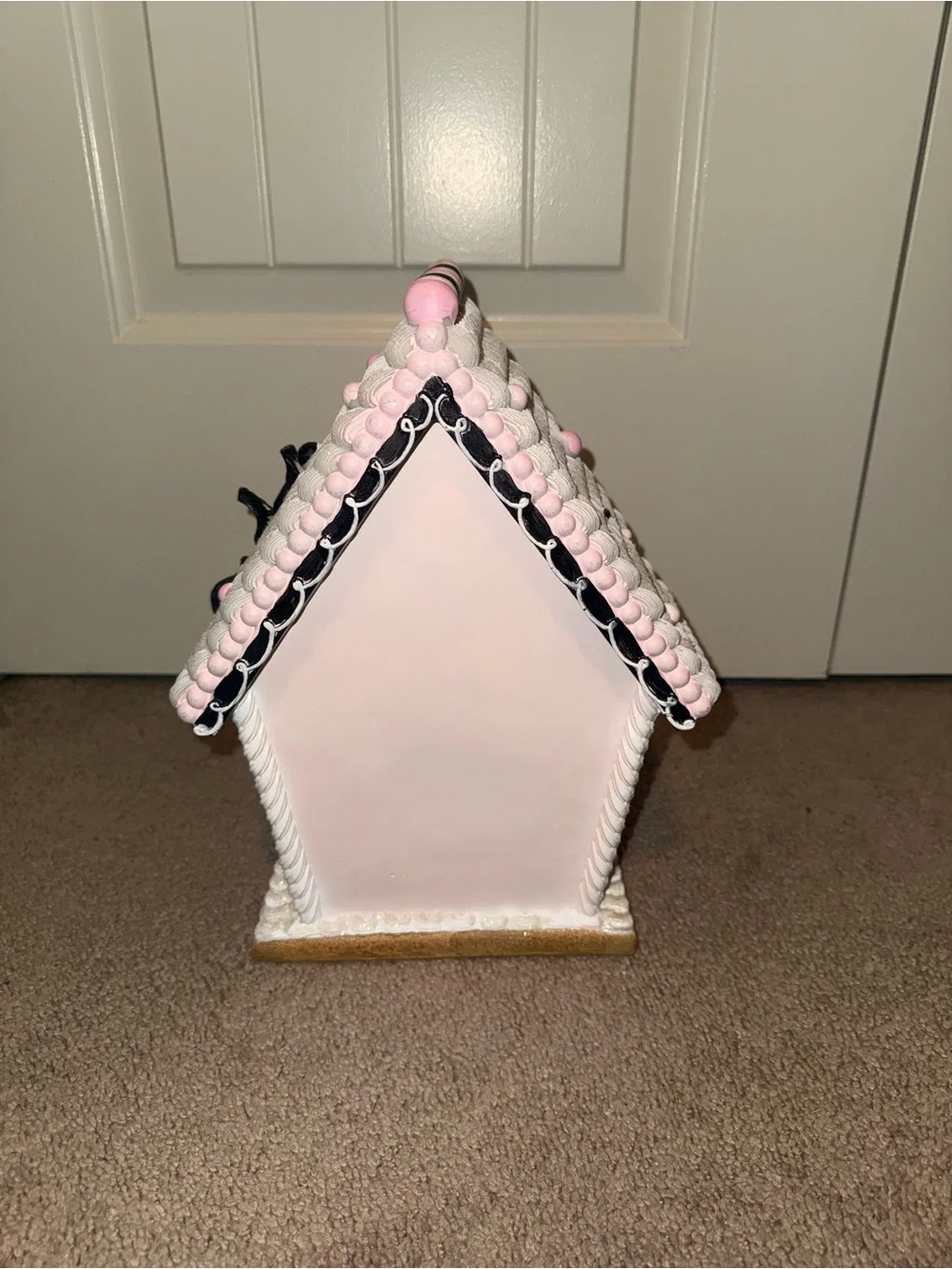 pink and black Halloween gingerbread house is a ceramic light-up figurine